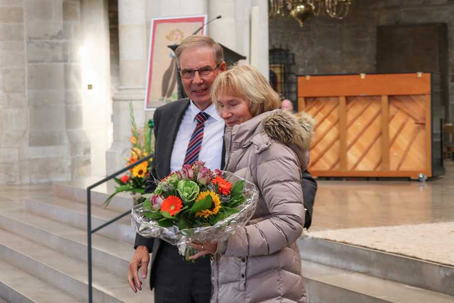 Ein Mann und eine Frau mit Blumen in einer Kirche.